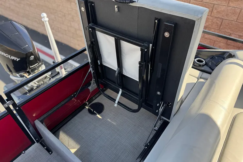 Slide: The Image of 2023 Regency 250 DL3 boat interior with Mercury engine, featuring seating and storage area. - 24