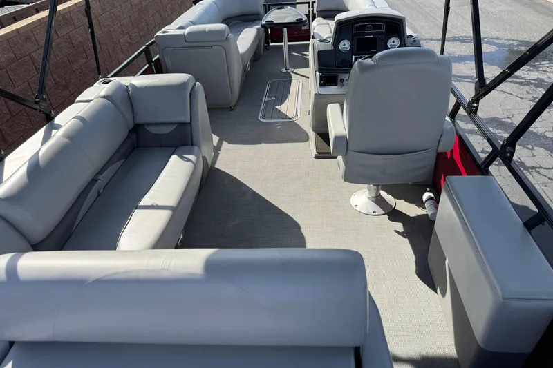 Slide: The Image of 2023 Regency 250 DL3 pontoon boat interior with gray seating and helm. - 27