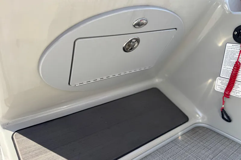 Slide: The Image of 2023 Regency 250 DL3 boat interior with storage compartment and safety lanyard. - 30