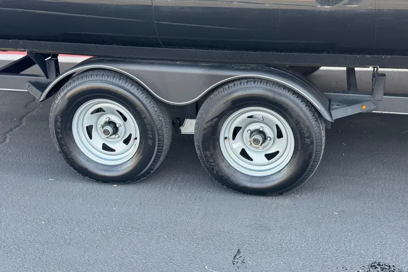 Slide: The Image of 2023 Regency 250 DL3 trailer with dual wheels on asphalt surface. - 33