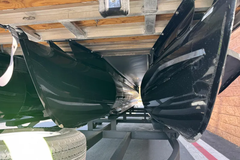 Slide: The Image of Underneath view of a 2023 Regency 250 DL3 pontoon boat on a trailer. - 4