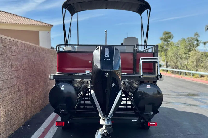 Slide: The Image of 2023 Regency 250 DL3 pontoon boat with powerful V8 engine, parked outdoors. - 5