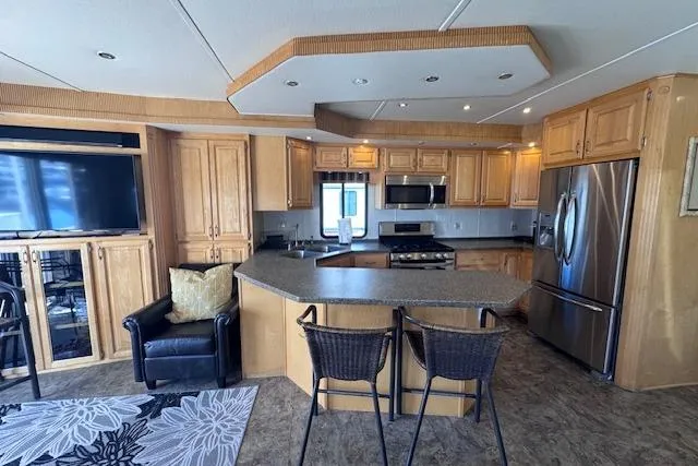 Slide: The Image of Luxurious yacht interior with modern kitchen, stainless steel appliances, and cozy seating area. - 11
