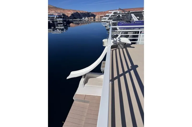 Slide: The Image of 2006 Destination Yachts yacht with slide, docked on calm water, clear sky. - 17