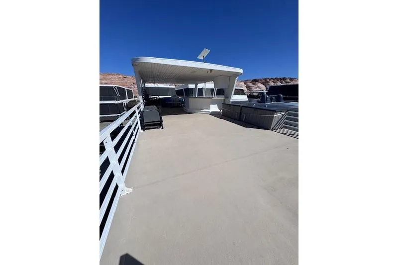 Slide: The Image of 2006 Destination Yachts yacht deck with railing, under clear blue sky. - 18