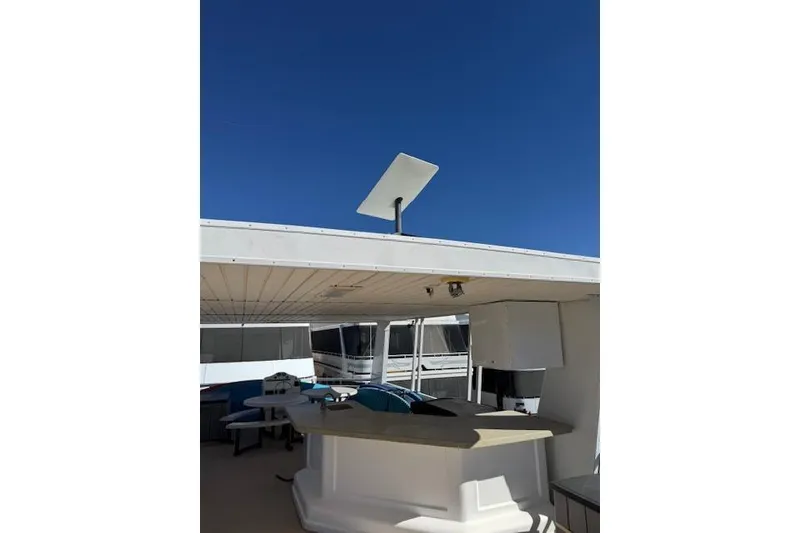 Slide: The Image of 2006 Destination Yachts yacht with outdoor seating and satellite dish under clear blue sky. - 23