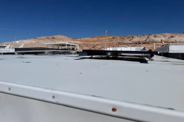 Slide: The Image of Rooftop view of 2006 Destination Yachts yacht against rocky landscape and clear blue sky. - 24