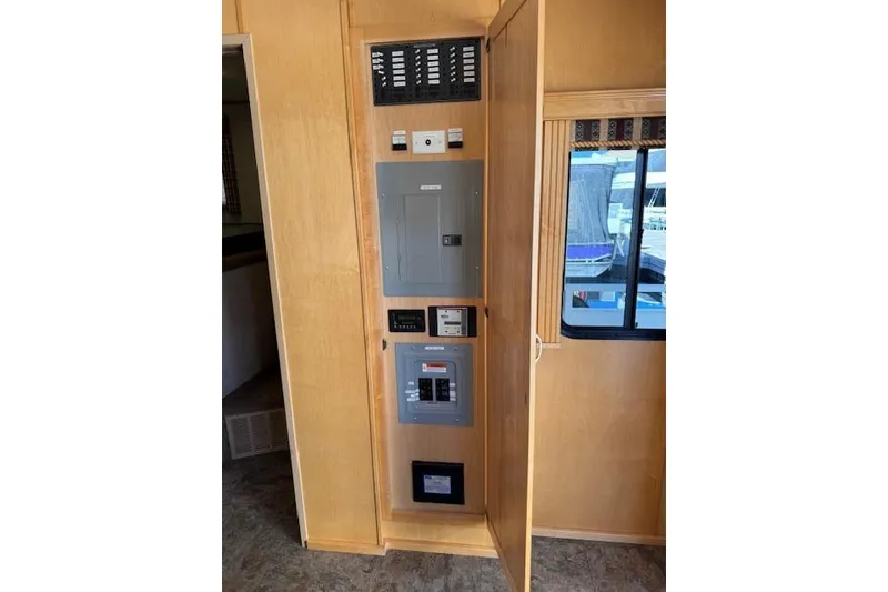 Slide: The Image of Electrical panel inside 2006 Destination Yachts Yacht Yet, featuring control switches and window view. - 5