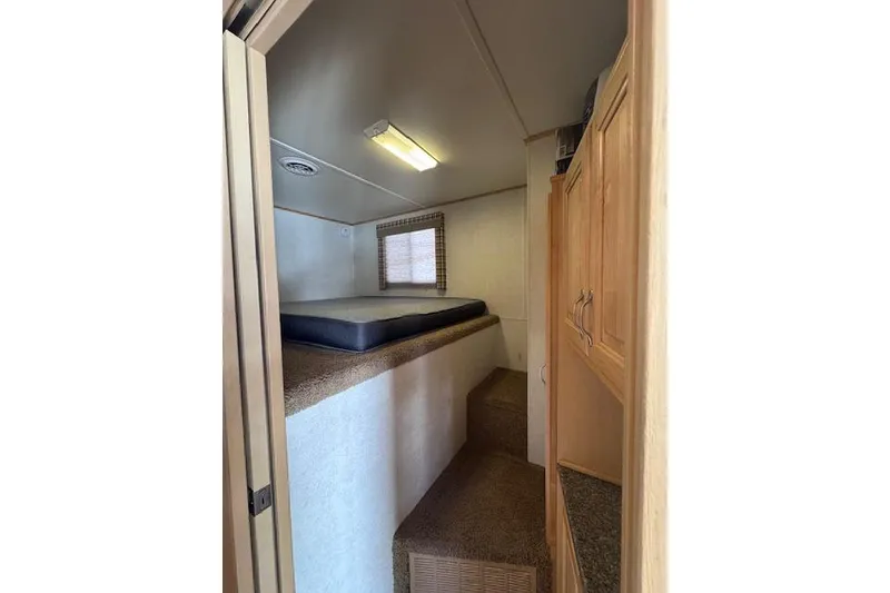 Slide: The Image of Cozy interior cabin of 2006 Destination Yachts, featuring a bed and wooden cabinetry. - 6