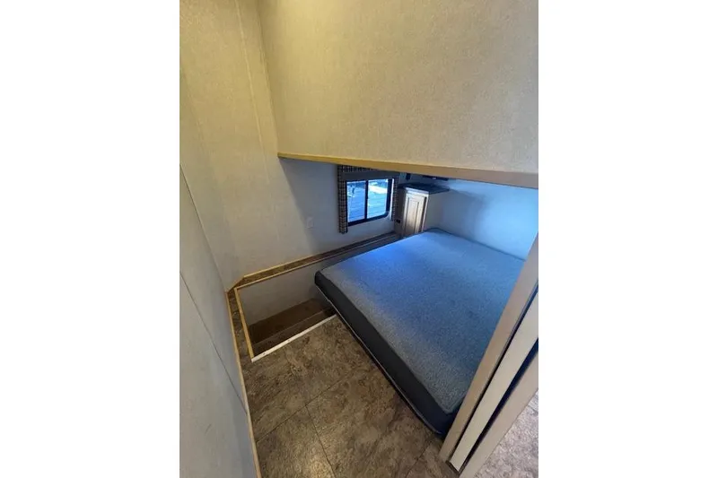 Slide: The Image of Cozy bedroom interior of 2006 Destination Yachts model, featuring a comfortable bed and window view. - 7