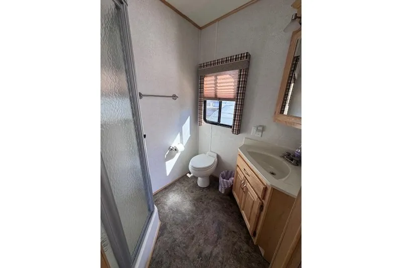 Slide: The Image of Bathroom interior of 2006 Destination Yachts model, featuring shower, toilet, and sink. - 9