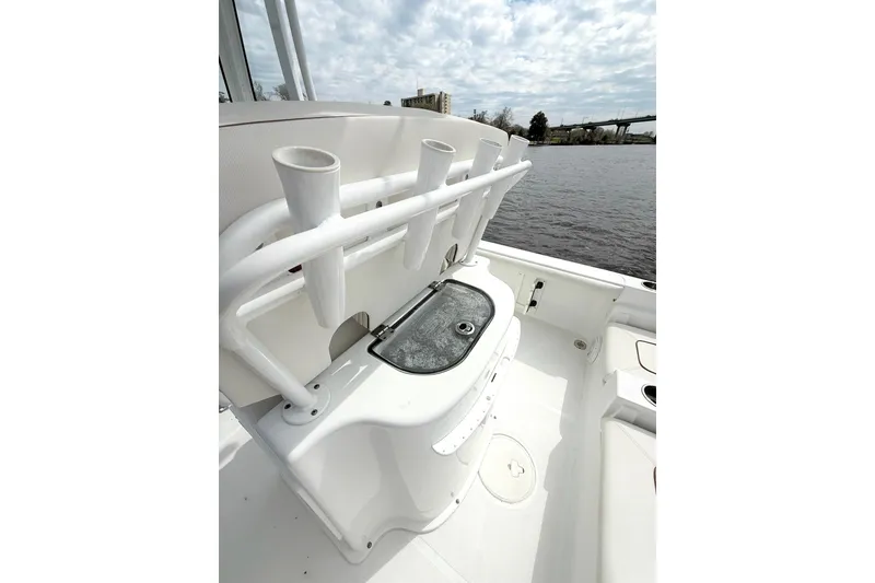 Slide: The Image of 2020 Sea Hunt BX 25 FS boat with rod holders and storage, docked by a river. - 15