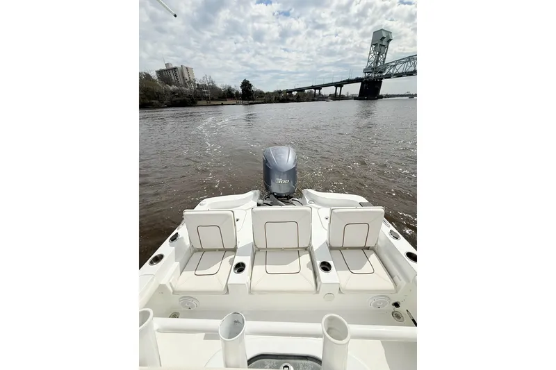Slide: The Image of 2020 Sea Hunt BX 25 FS boat on a river with bridge in background. - 17