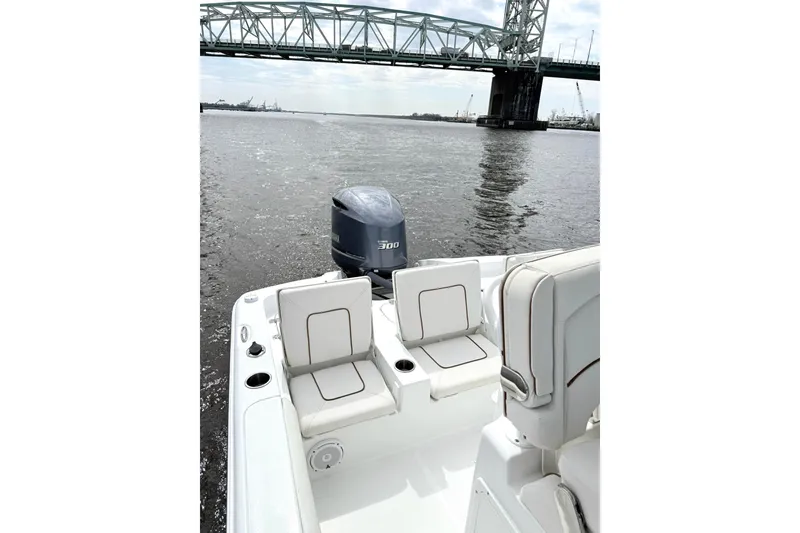 Slide: The Image of 2020 Sea Hunt BX 25 FS boat on water near a bridge, featuring comfortable seating and powerful engine. - 18