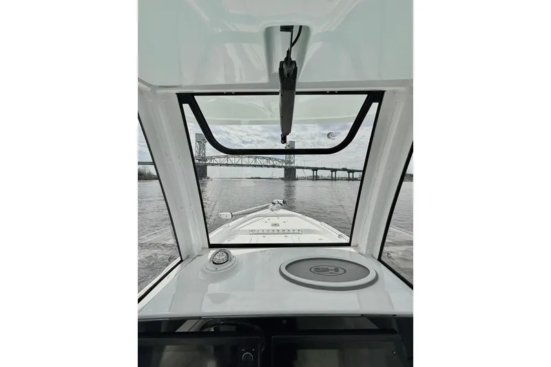 Slide: The Image of Interior view from a 2020 Sea Hunt BX 25 FS boat, approaching a bridge on the water. - 7
