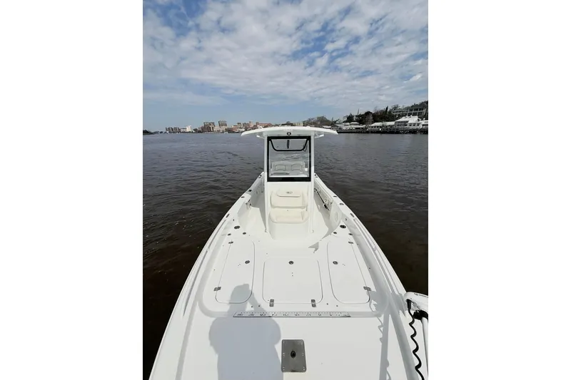 Slide: The Image of 2020 Sea Hunt BX 25 FS boat on calm water under a partly cloudy sky. - 9
