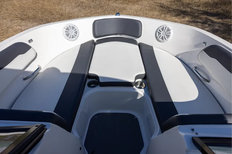 Slide: The Image of 2021 Bayliner VR6 Bowrider OB interior with cushioned seating and cup holders. - 11