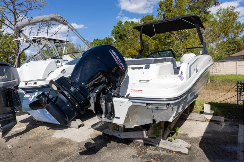 Slide: The Image of 2021 Bayliner VR6 Bowrider OB with Mercury outboard engine, parked outdoors. - 2