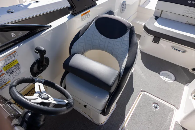 Slide: The Image of 2021 Bayliner VR6 Bowrider OB cockpit with steering wheel and cushioned seat. - 9