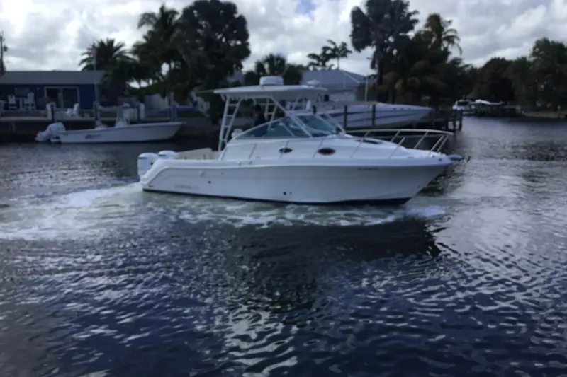 The Image of 2017 Robalo R305 Walkaround boat cruising on a calm waterway. - 0