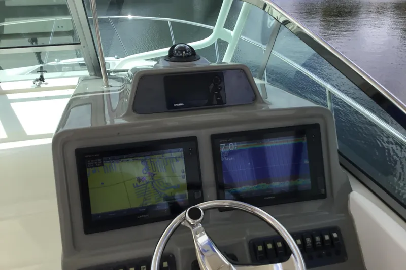Slide: The Image of 2017 Robalo R305 Walkaround helm with dual Garmin displays and steering wheel. - 13
