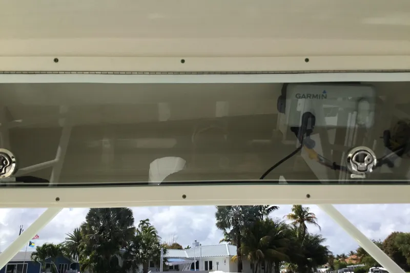 Slide: The Image of 2017 Robalo R305 Walkaround with Garmin equipment, docked near palm trees. - 16