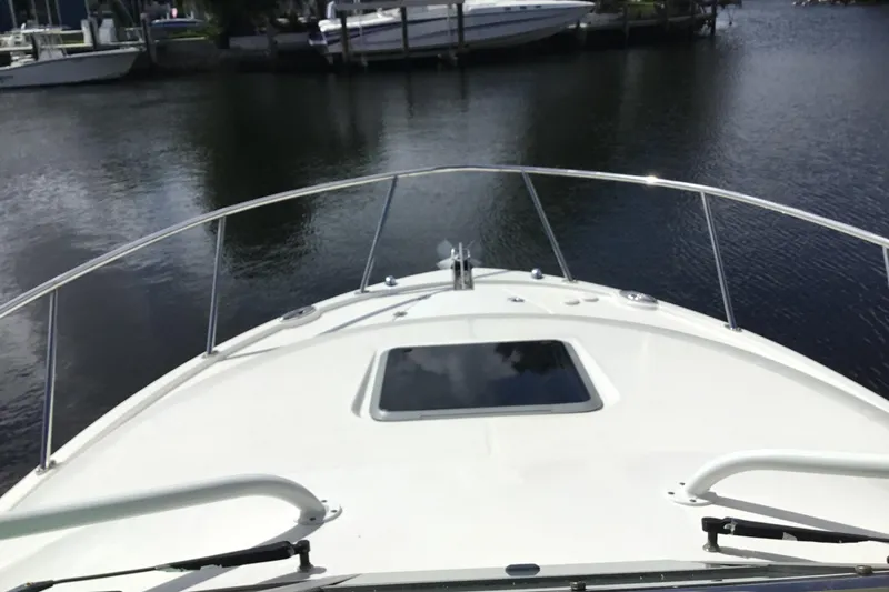Slide: The Image of 2017 Robalo R305 Walkaround boat on calm water, view from bow. - 17