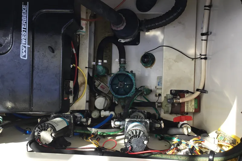 Slide: The Image of Engine compartment of a 2017 Robalo R305 Walkaround boat with visible wiring and components. - 24