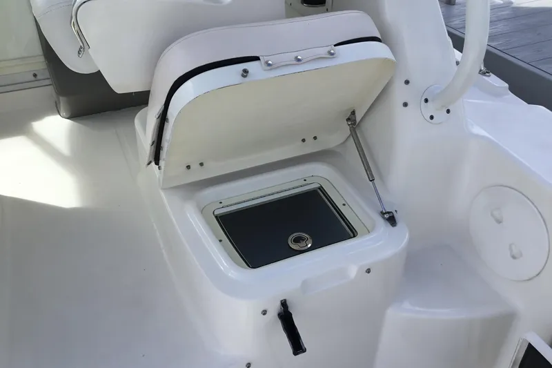 Slide: The Image of 2017 Robalo R305 Walkaround boat seat storage compartment open. - 26