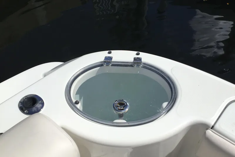 Slide: The Image of 2017 Robalo R305 Walkaround boat livewell with clear lid on deck. - 29