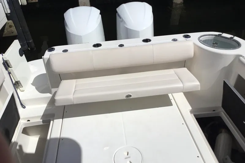 Slide: The Image of 2017 Robalo R305 Walkaround boat interior with seating and dual engines. - 30