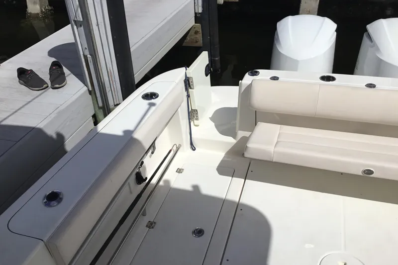Slide: The Image of 2017 Robalo R305 Walkaround boat interior with seating and docked shoes. - 31