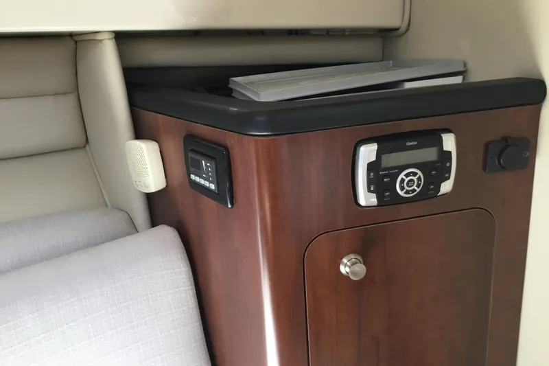 Slide: The Image of Interior of 2017 Robalo R305 Walkaround boat with wood paneling and audio system. - 36
