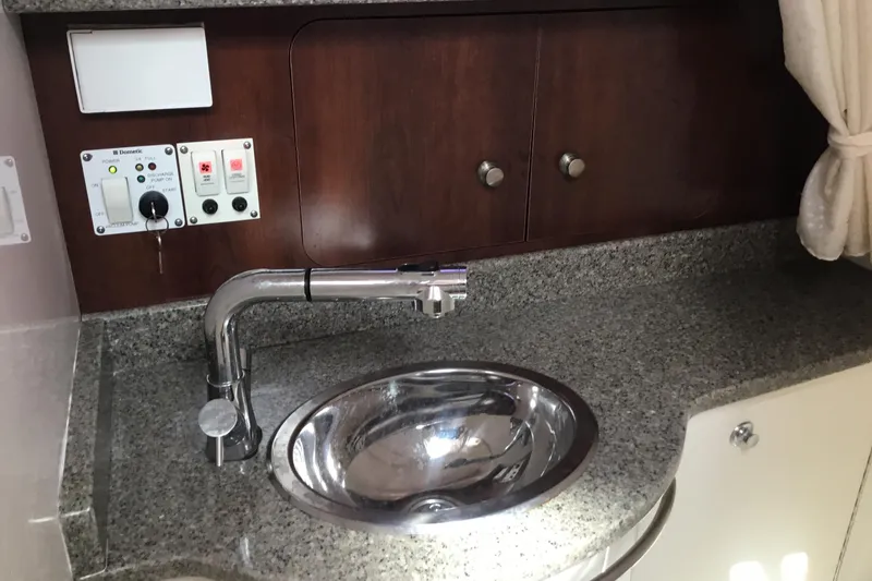 Slide: The Image of 2017 Robalo R305 Walkaround boat interior with sink and control panel. - 37