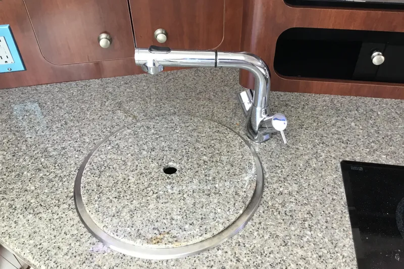 Slide: The Image of Granite countertop with sink and faucet on 2017 Robalo R305 Walkaround boat. - 40