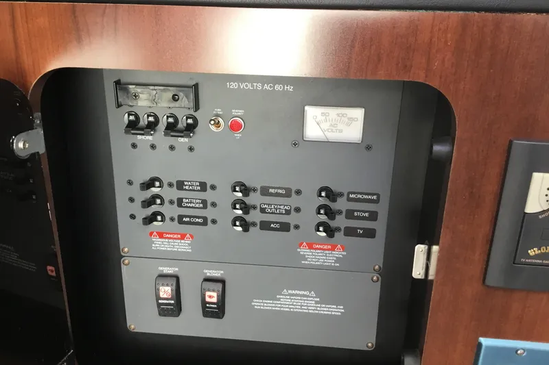 Slide: The Image of Electrical control panel on 2017 Robalo R305 Walkaround boat, featuring switches and voltage meter. - 41