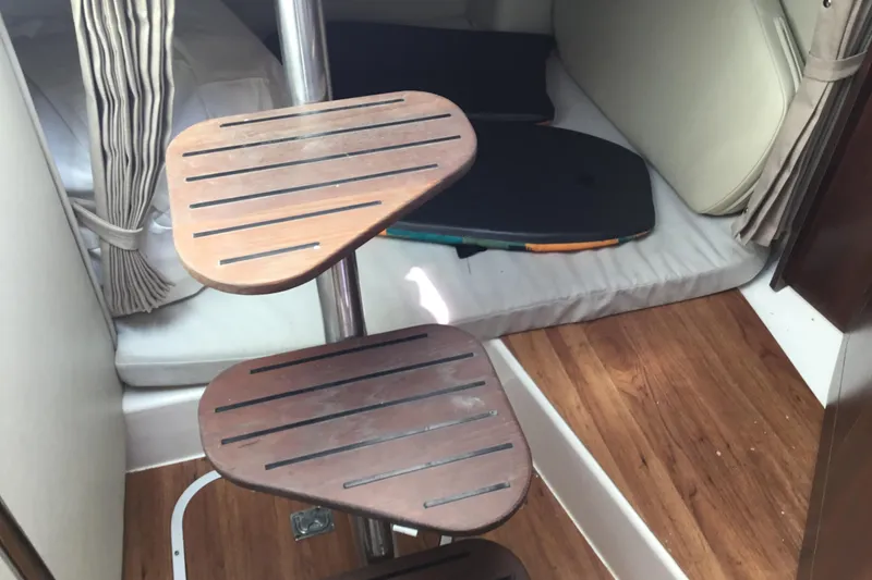 Slide: The Image of Interior of 2017 Robalo R305 Walkaround boat with wooden steps and cozy cabin space. - 43