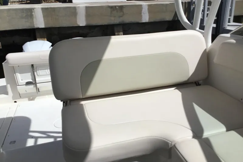 Slide: The Image of 2017 Robalo R305 Walkaround boat interior with beige seating and shadow play. - 44