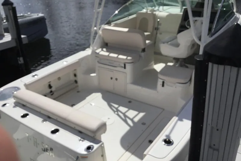 Slide: The Image of 2017 Robalo R305 Walkaround boat with spacious seating and sleek design at the dock. - 45