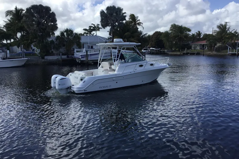 Slide: The Image of 2017 Robalo R305 Walkaround boat cruising on a calm waterway. - 49