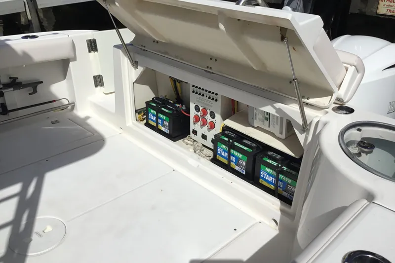 Slide: The Image of 2017 Robalo R305 Walkaround boat battery compartment with Interstate batteries and control panel. - 53
