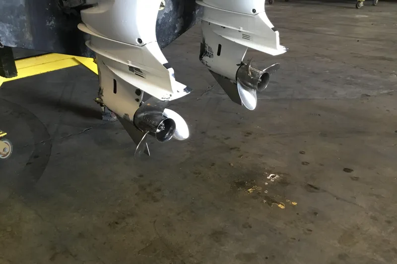 Slide: The Image of 2017 Robalo R305 Walkaround boat propellers in a garage setting. - 56