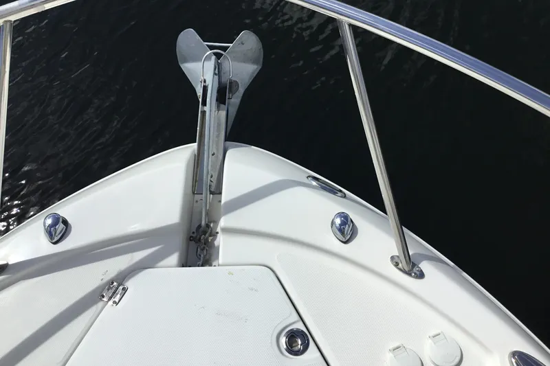 Slide: The Image of Bow of 2017 Robalo R305 Walkaround boat with anchor and railing. - 8