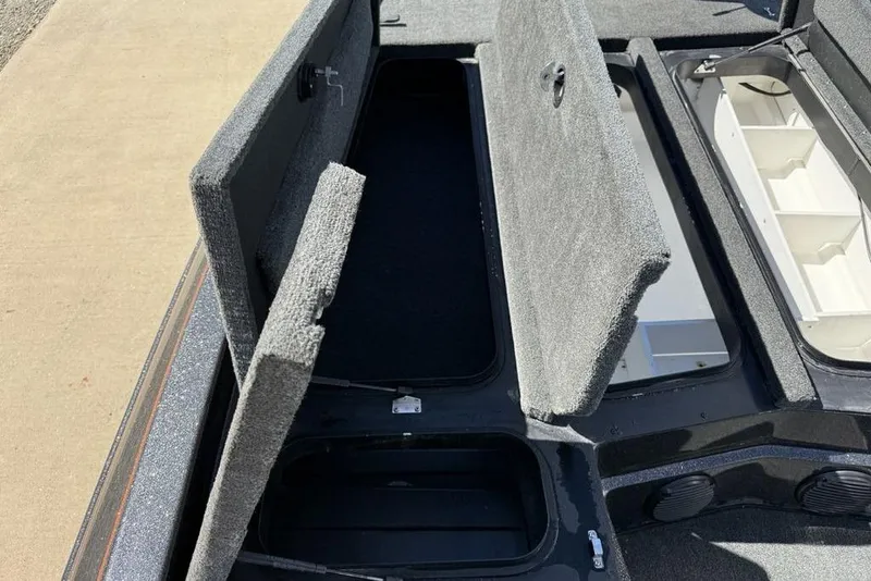 Slide: The Image of 2019 Skeeter ZX250 boat storage compartments open, showcasing interior space. - 10