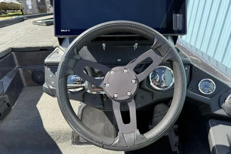 Slide: The Image of Steering wheel of a 2019 Skeeter ZX250 boat with dashboard instruments. - 13