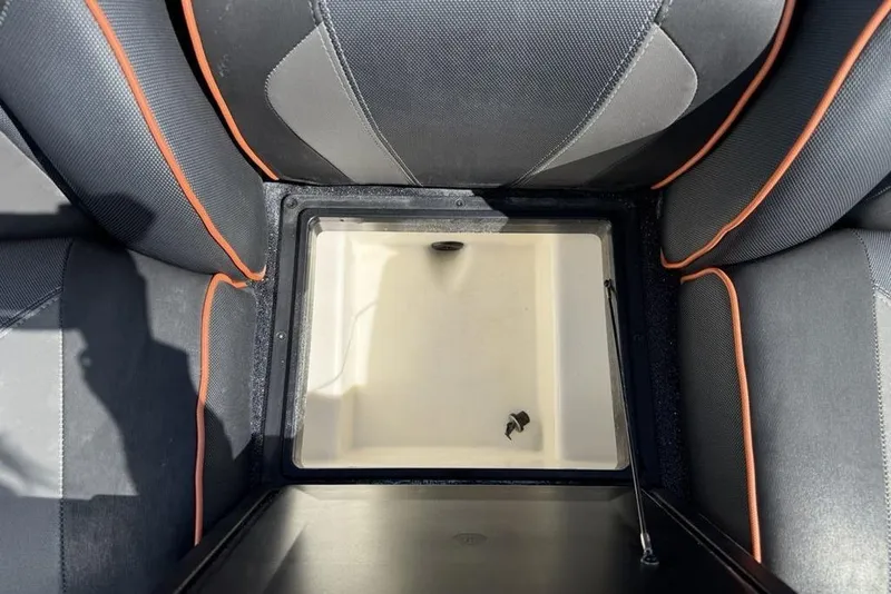 Slide: The Image of 2019 Skeeter ZX250 boat storage compartment with black and orange seating. - 21