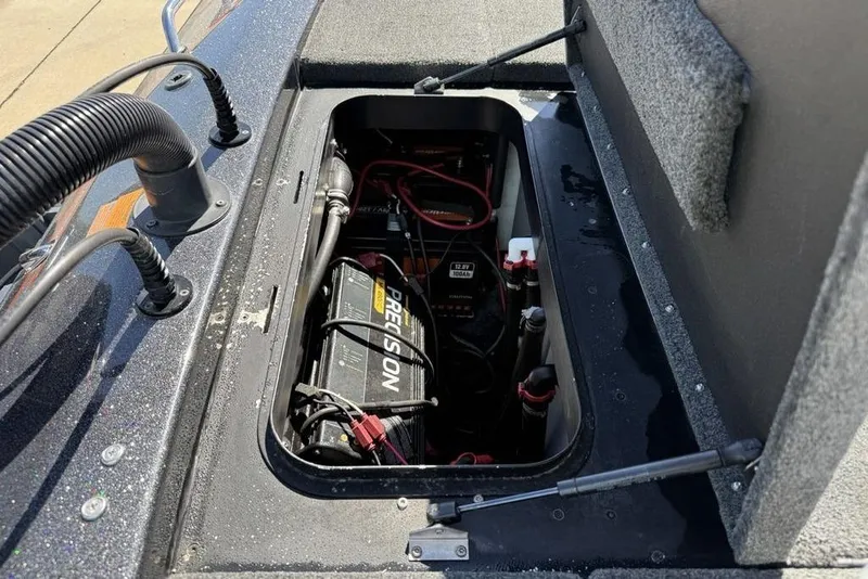 Slide: The Image of 2019 Skeeter ZX250 boat battery compartment with wiring and Precision charger. - 23