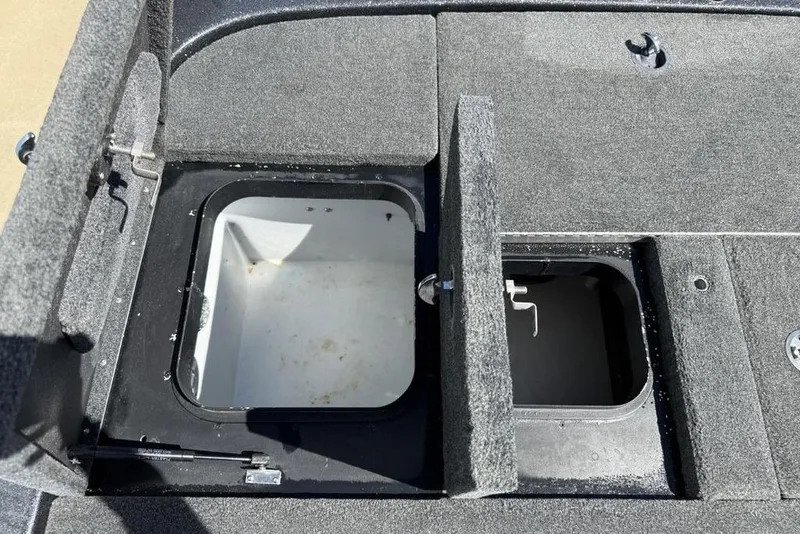 Slide: The Image of 2019 Skeeter ZX250 boat storage compartments with open lids, showcasing interior space. - 24