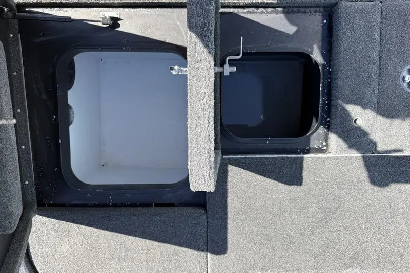 Slide: The Image of 2019 Skeeter ZX250 boat storage compartments with open lids, showcasing interior space. - 26