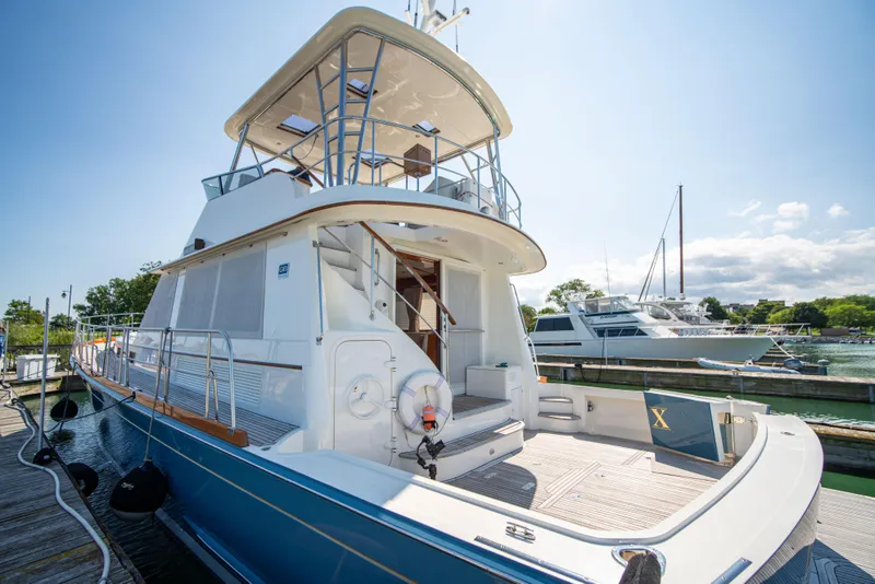 Slide: The Image of 2004 Grand Banks 58 Eastbay FB yacht docked under clear skies. - 1